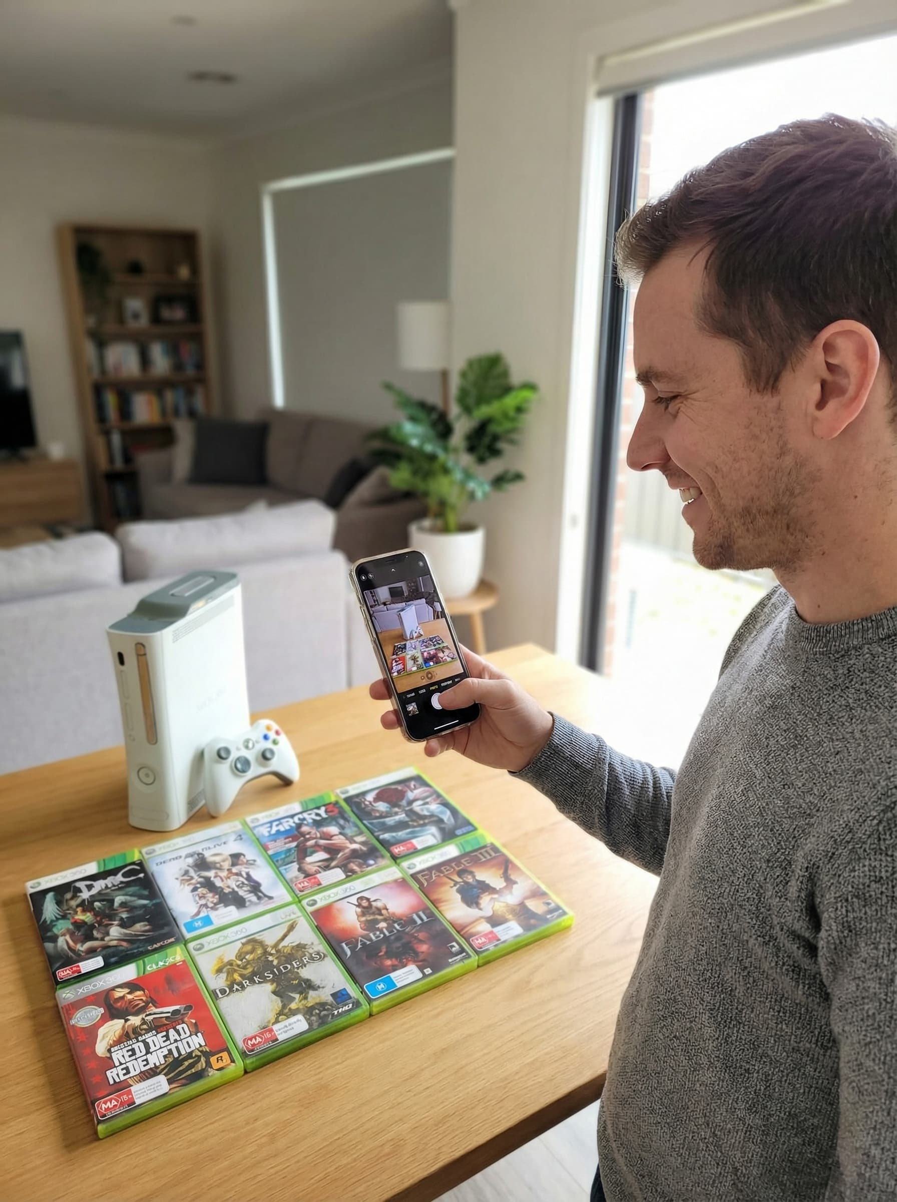 Person fotografiert eine Xbox 360 Sammlung