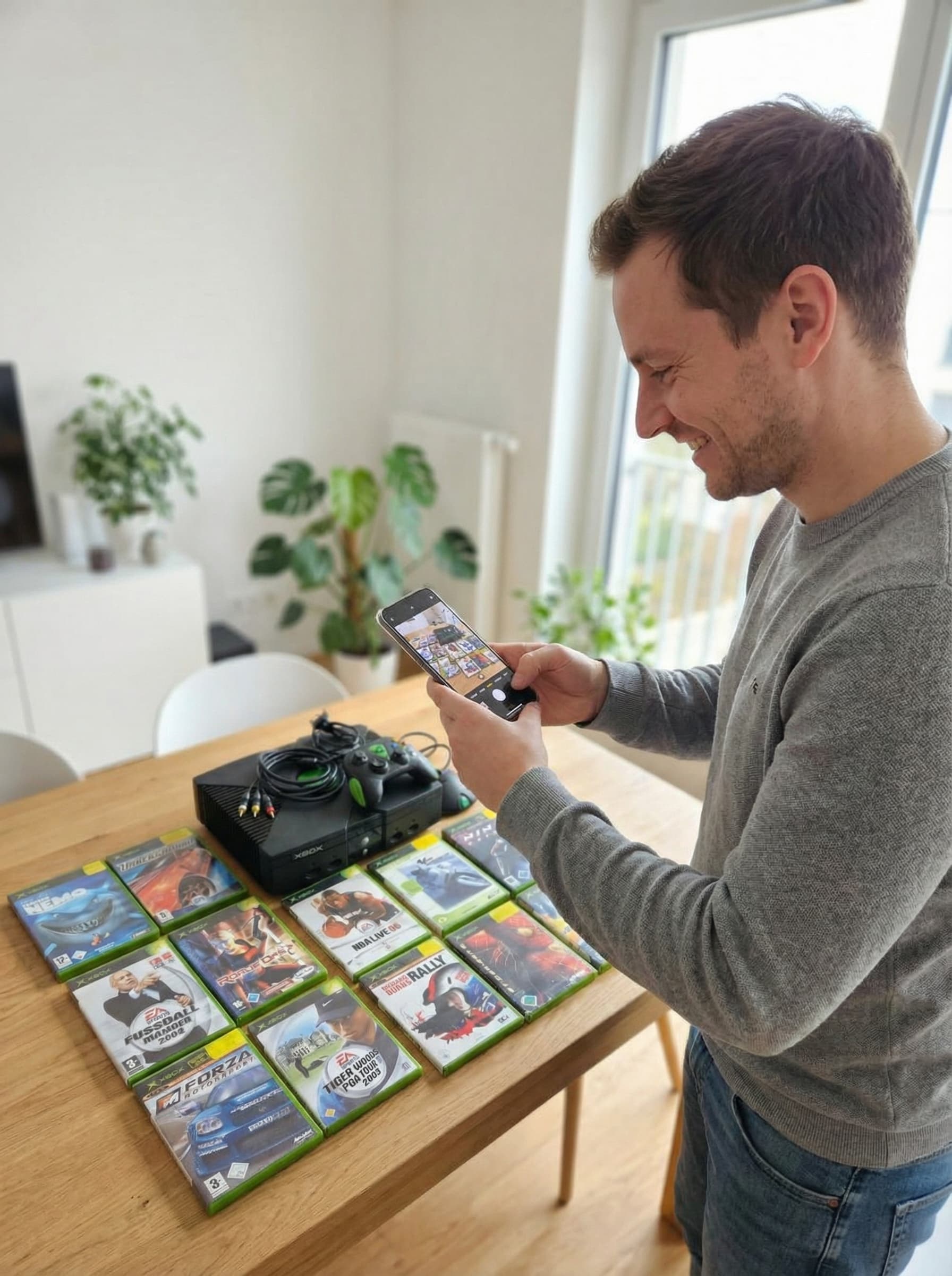 Person fotografiert eine Xbox Sammlung